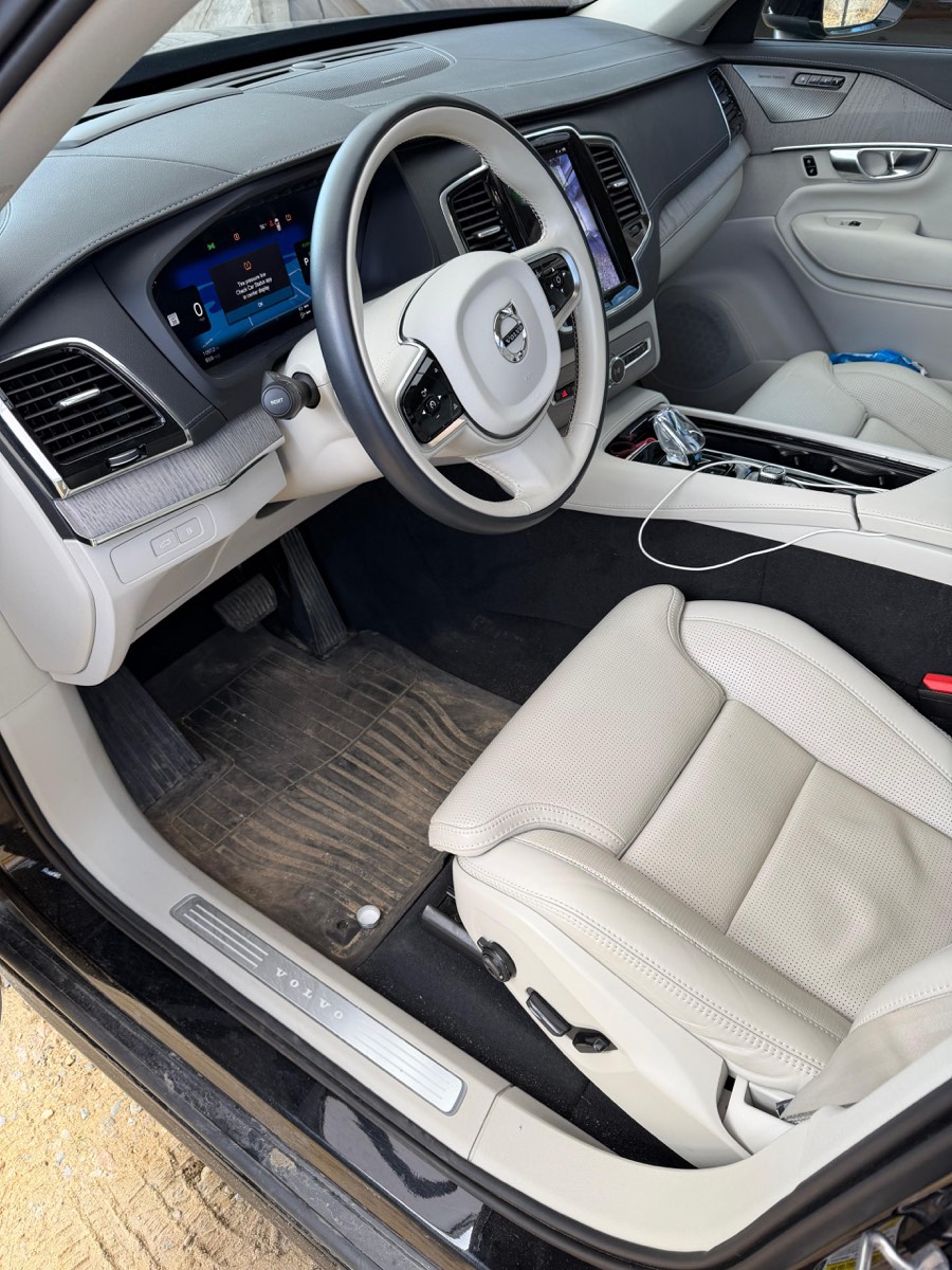 Volvo XC90 interior before detailing — soiled mats and carpet