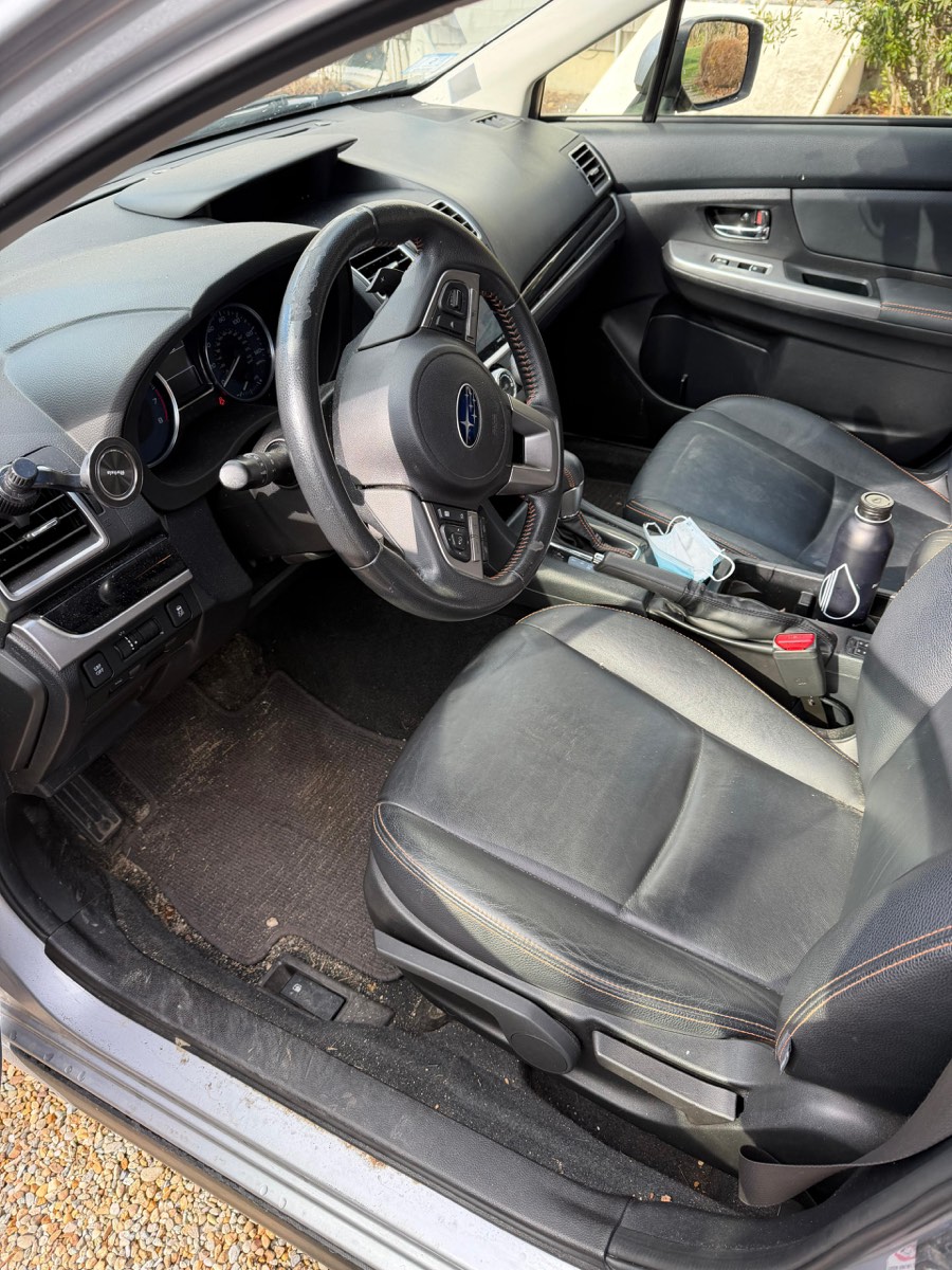 Subaru interior before detailing — grimy carpet and dusty dash